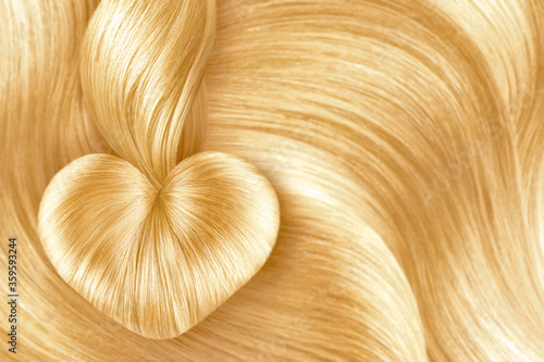 Heart made by natural blond hair. Creative background