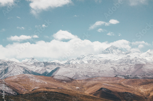 Mount Everest in Tibet, China, with a classic flag cloud on it.