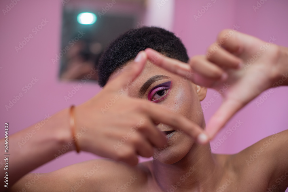 © rushay - Portrait of young queer male watching through his fingers © rushay - Portrait of young queer male watching through his fingers