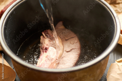 Cooking meat broth. Add water to the meat pan.