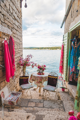 Fototapeta Naklejka Na Ścianę i Meble -  sweet cozy place table at the edge if the beach between building