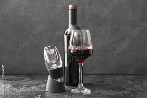 Принти на полотні Aerator with bottle and glass of wine on dark background