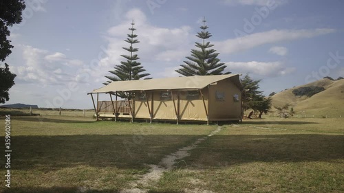 walking through towowards a safari tent on the grass .mov photo