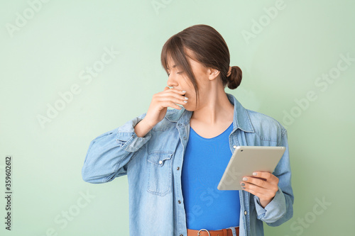 Tired woman with tablet com...