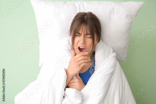 Tired woman with bedding on...