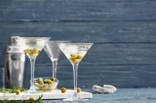 Fotografie Glasses of tasty martini cocktail with olives on table