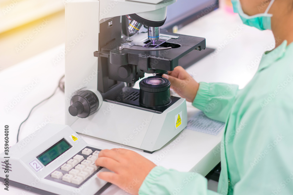 Doctor and microbiologist with vacuum tubes for samples with COVID 19 infection atypical pneumonia virus in laboratory Doctor and microbiologist with vacuum tubes for samples with COVID 19 infection atypical pneumonia virus in laboratory