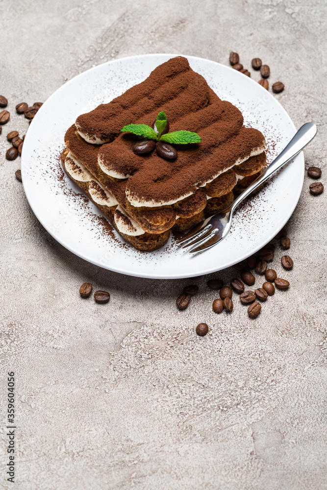 Classic tiramisu dessert on ceramic plate on concrete background Classic tiramisu dessert on ceramic plate on concrete background