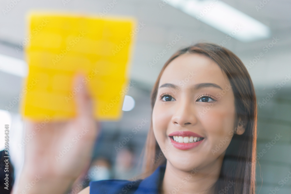 business woman working and use post it notes to share idea on the glass board in office. Lifestyle business meeting concept. depressed businesswoman business woman working and use post it notes to share idea on the glass board in office. Lifestyle business meeting concept. depressed businesswoman