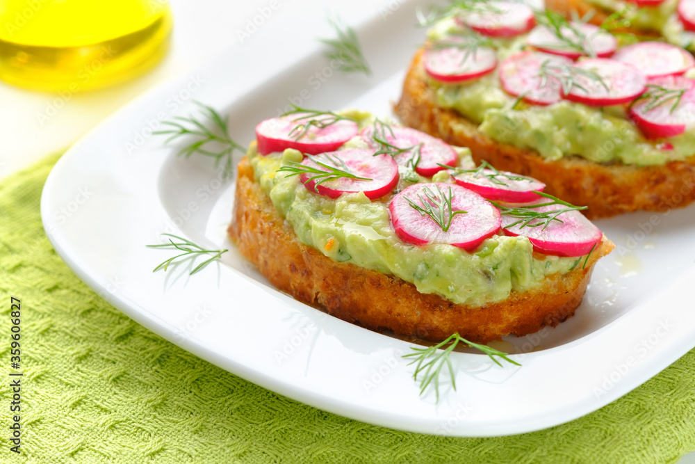 Delicious vegan sandwiches with radish and avocado. Horizontal orientation.
