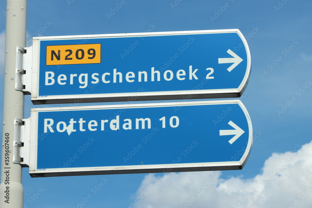 Blue and white signpost to Bergschenhoek village and Rotterdan town via provincial road N209 in Bleiswijk, the Netherlands. Blue and white signpost to Bergschenhoek village and Rotterdan town via provincial road N209 in Bleiswijk, the Netherlands.