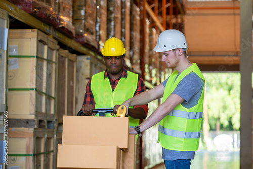 Warehouse worker loading or unloading boxes at warehouse,Logistics concept.