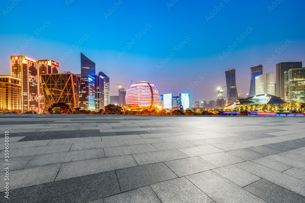 Empty square floor and modern city scenery at night in Hangzhou,China.