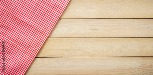 Classic pink tablecloth on wood plank with copy space
