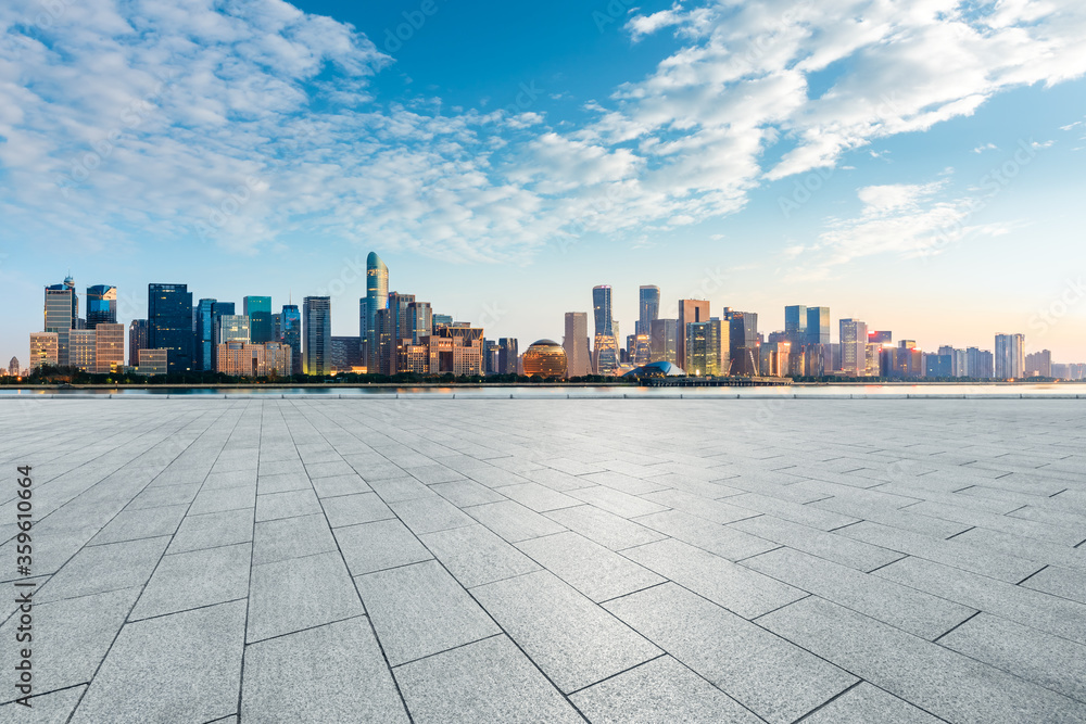 Empty square floor and modern city scenery at sunrise in Hangzhou,China. Empty square floor and modern city scenery at sunrise in Hangzhou,China.