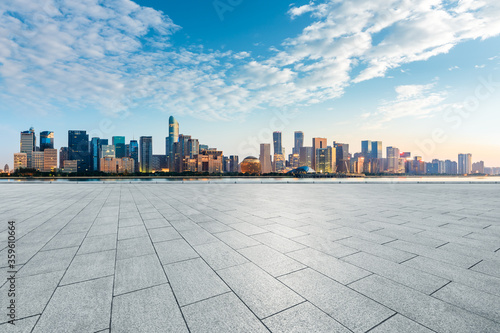 Empty square floor and modern city scenery at sunrise in Hangzhou,China.