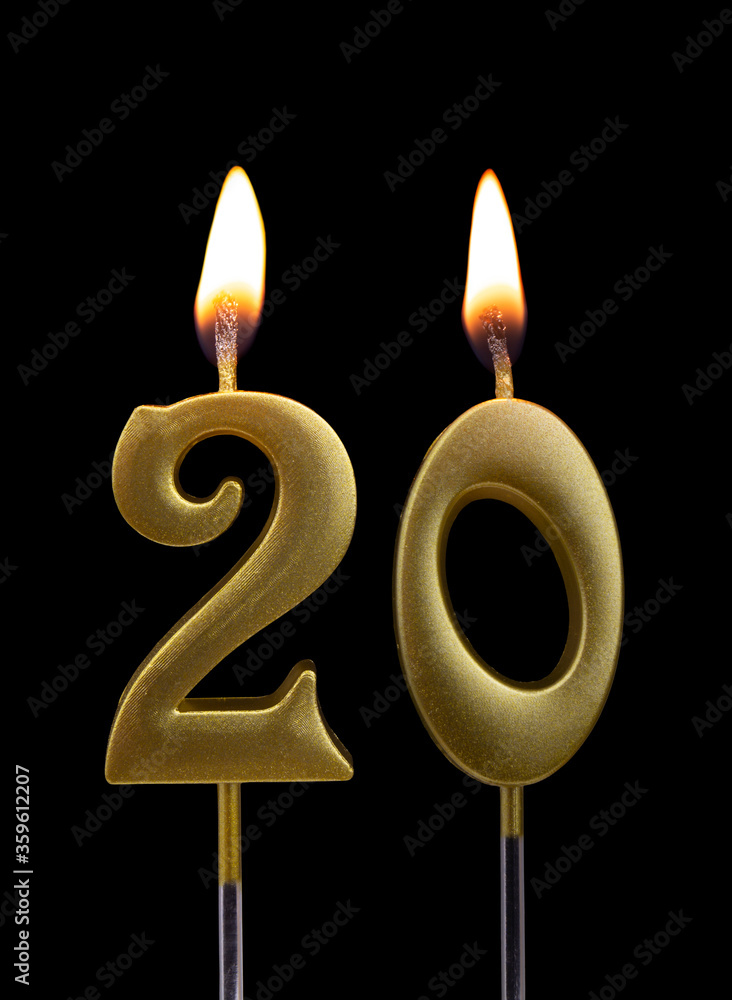 Burning golden birthday candles isolated on black background, number 20 Burning golden birthday candles isolated on black background, number 20