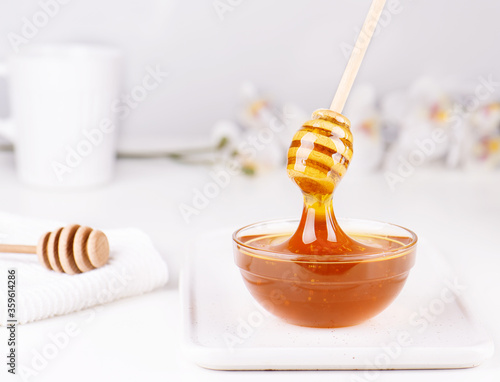Honey in the bowl on white background
