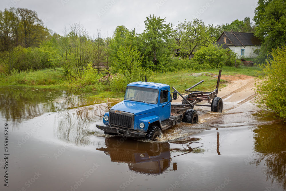 timber truck crosses the ford river