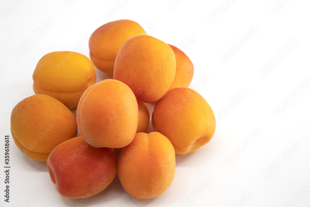 Fresh apricots lie on a white background Fresh apricots lie on a white background
