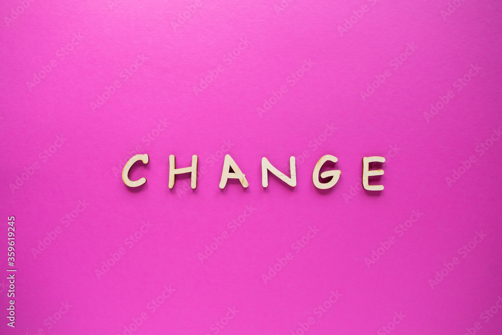 Change words written by wooden letters on a color background. Top view Change words written by wooden letters on a color background. Top view