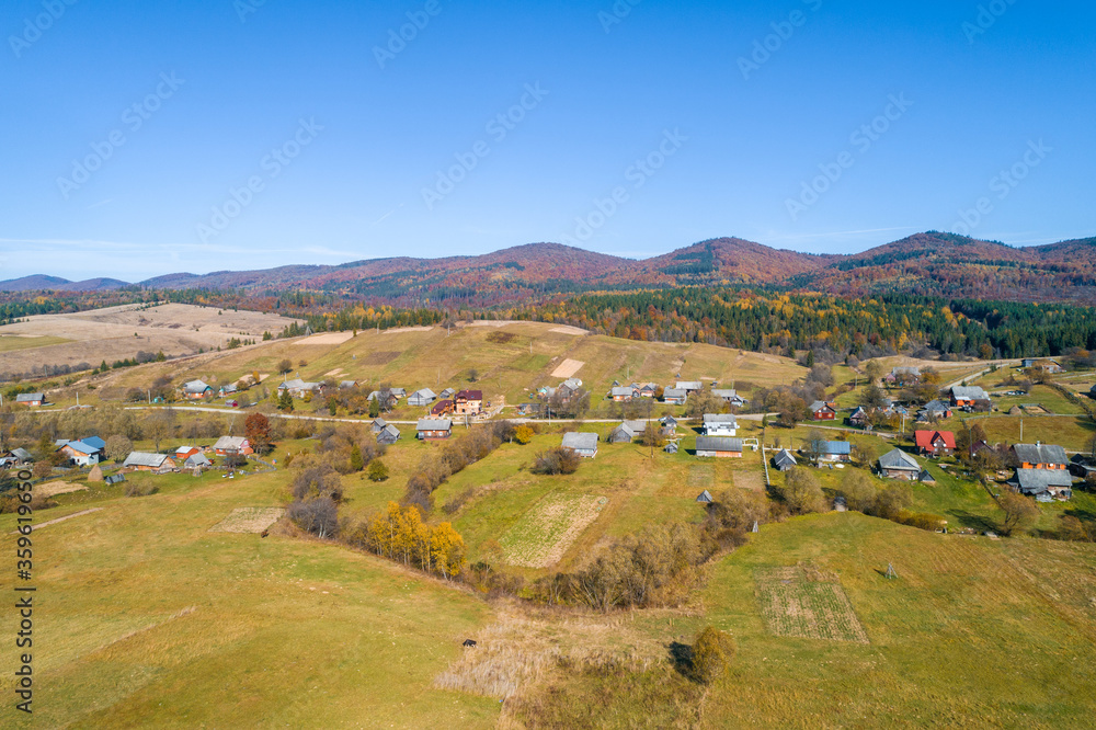 Panoramic aerial view of the mountain village in autumn. Beautiful countryside landscape. Carpathian mountains. Ukraine