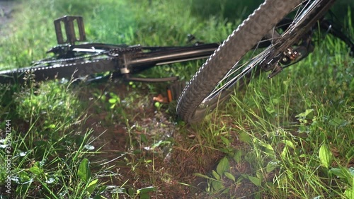 Wallpaper Mural After falling from the bike. Accident while cycling. Mountain bike wheel rotates close up. Mountain bike fell, FRONT wheel rotates. Green grass. Selective focus. Torontodigital.ca