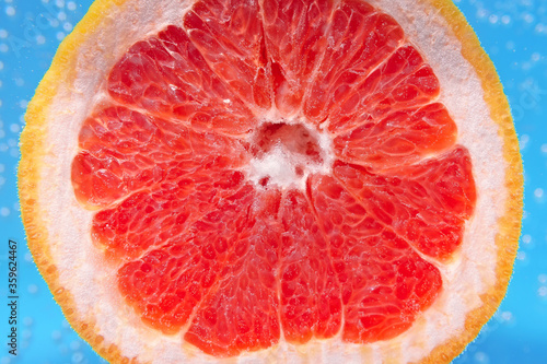 red citrus- fruit slices of grapefruit. To close. ripe juicy fruit in water, under water, for juice