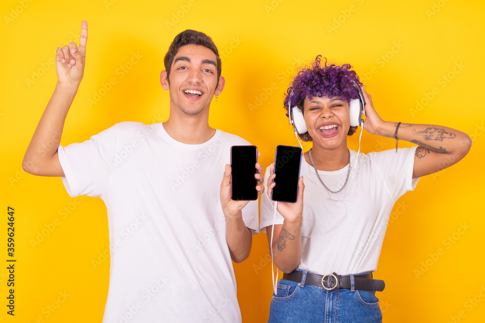 isolated young boy and girl couple with cellphones and headphones isolated young boy and girl couple with cellphones and headphones