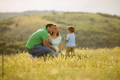 Young family having fun outdoors in the field