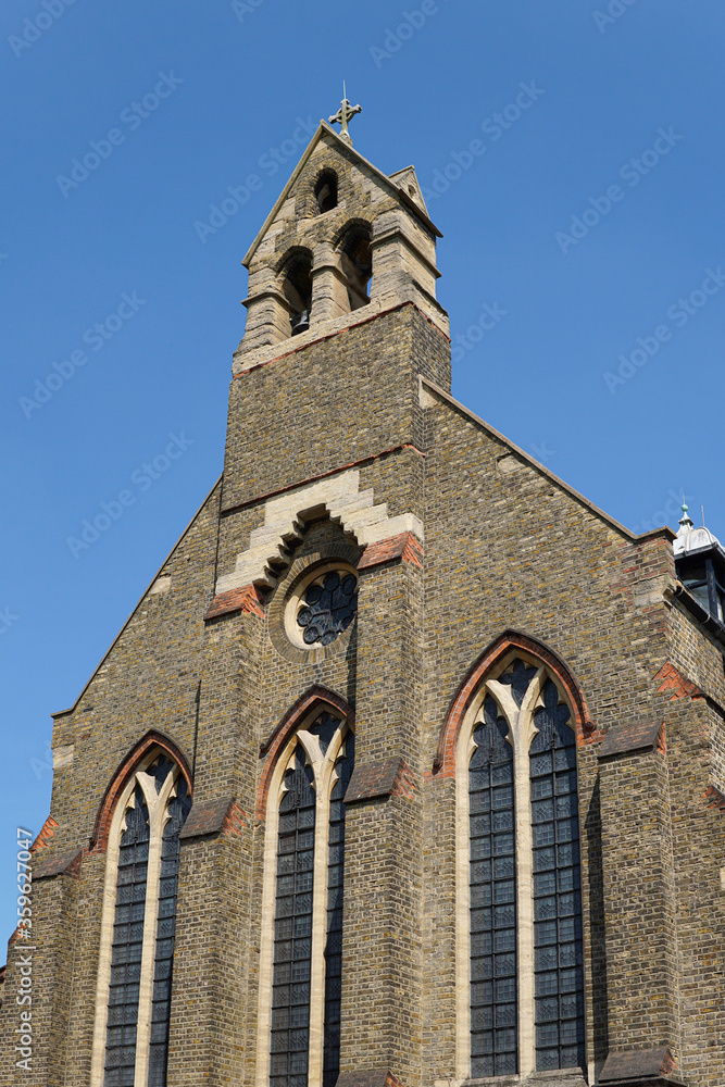 The weathered stone exterior of St Mary Magdalene Church of England church on Trinity Road near Wandsworth Common, London.  Image has copy space.