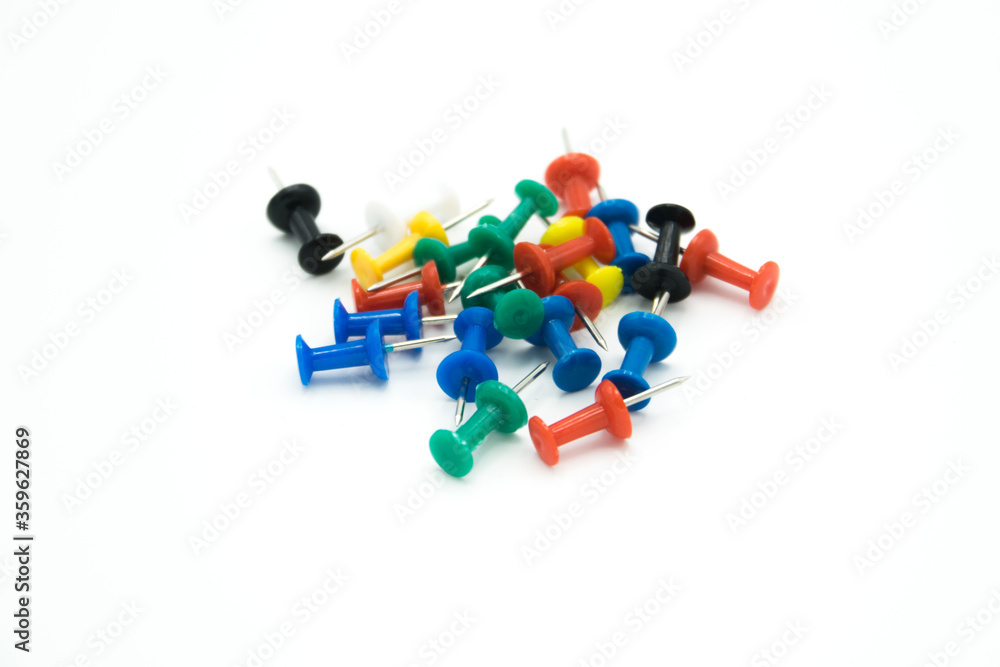 colored pushpins on a white background colored pushpins on a white background