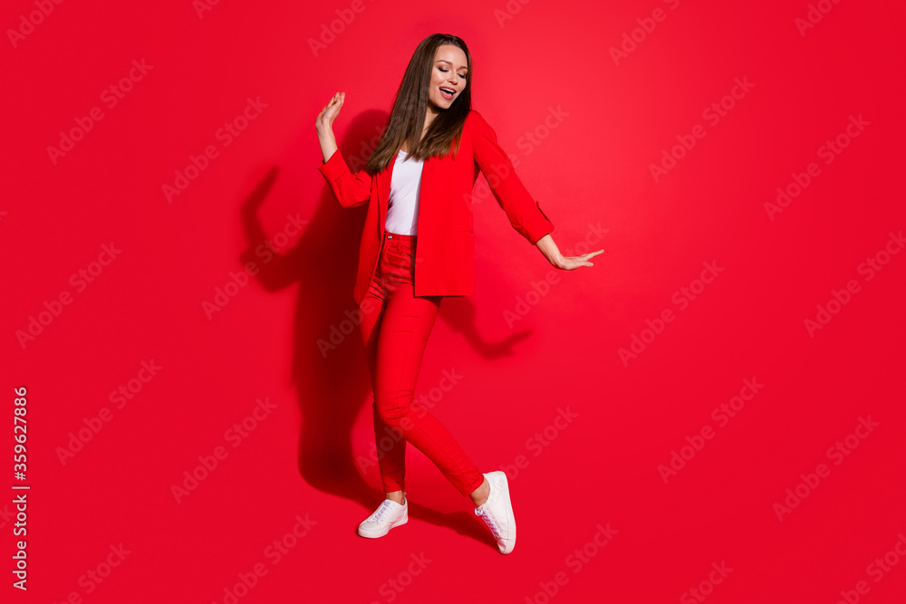 Full length photo of attractive funny business lady successful worker having fun dance corporate party colleagues event wear blazer suit pants shoes isolated red color background Full length photo of attractive funny business lady successful worker having fun dance corporate party colleagues event wear blazer suit pants shoes isolated red color background