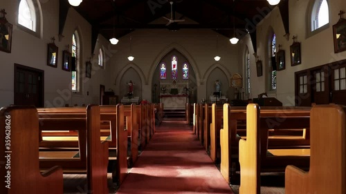 Empty church with wooden pews, facing down aisle to pulpit photo