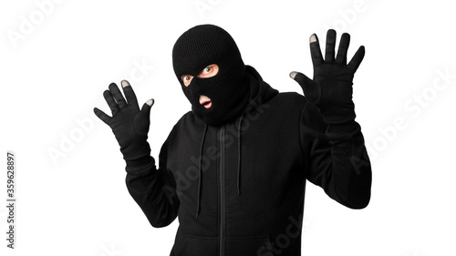 Cuadro en lienzo Arrested masked thief with raised arms isolated on white wall