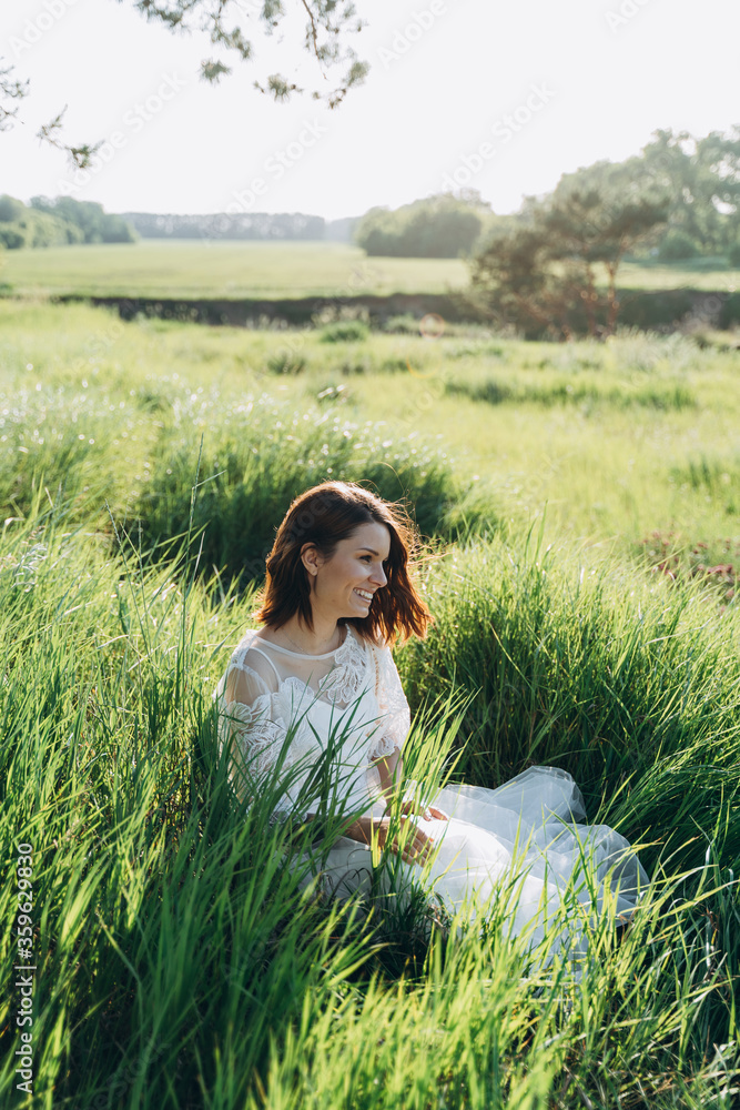 portrait of woman wearing white dress sitting in the field portrait of woman wearing white dress sitting in the field