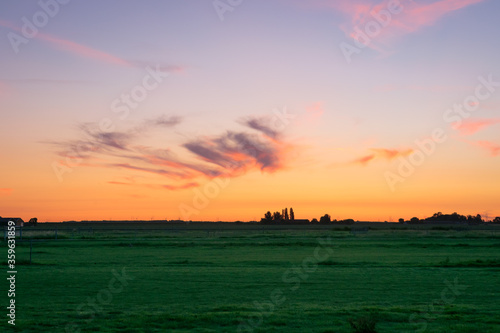 Beautiful pink colored cirrus clouds over the dutch countryside during the period of the longest days