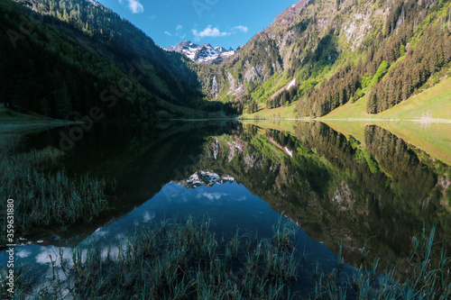 The awesome Schladminger Tauern mountains reflecting at the tranquil water surface of the Steirischer Bodensee, Schladming region, Styria, Austria