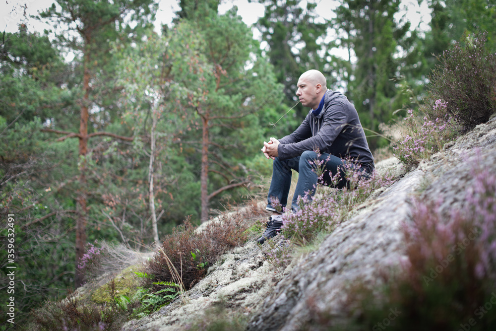 Adult man lost while hiking  in the forest.