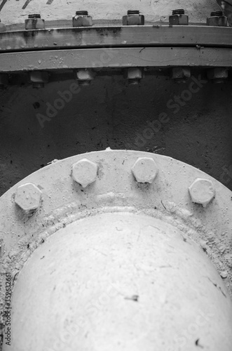 A fragment of a large gas pipe with bolted fasteners close 