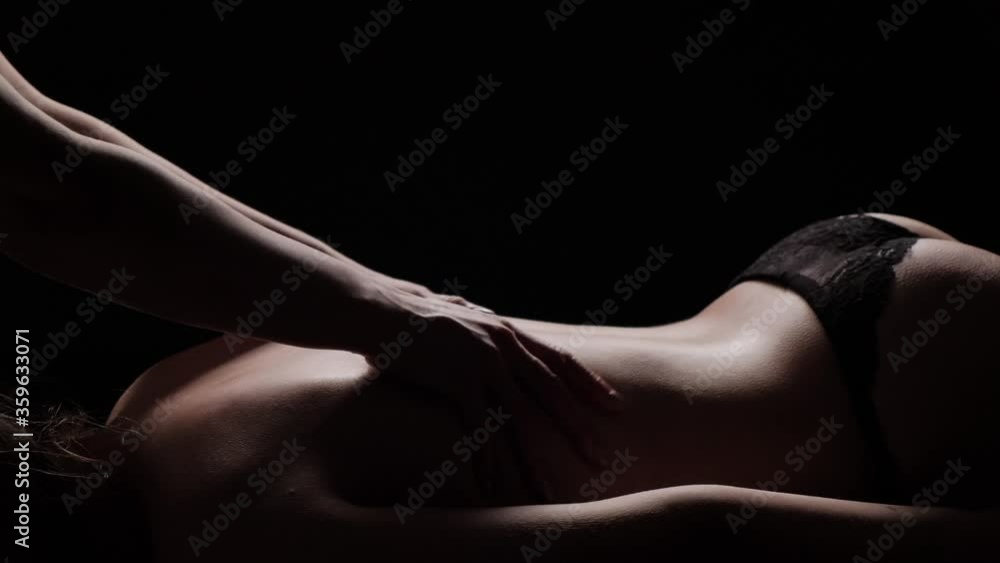Back massage on a dark background close-up. A woman in a spa salon does a relaxing massage. Back massage on a dark background close-up. A woman in a spa salon does a relaxing massage.