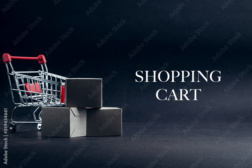 SHOPPING CART text with shopping cart on dark background. Business, Copy space and online shopping concept. Selective focus