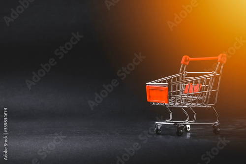 Shopping cart on dark background. Business, Copy space and online shopping concept. Selective focus