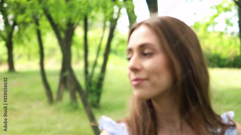 Beautiful young woman walking in the park and enjoying nature
Beautiful young woman walking in the park and enjoying nature