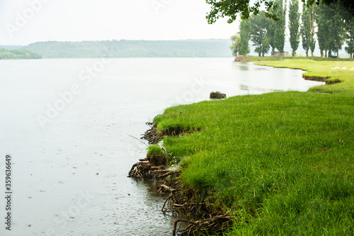 Beautiful summer landscape in Republic of Moldova. Green landscape. Nature. Park with Green Grass and River NIstru under the rain. Travel in Europ. Picturesque place. photo