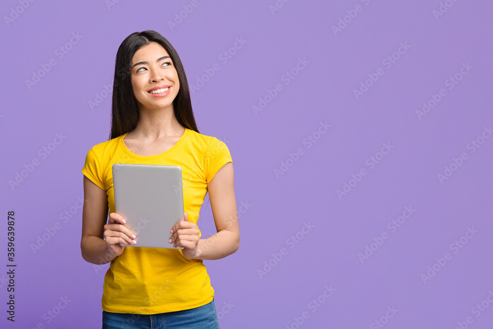 Modern Technologies And Millennials. Portrait of pensive asian girl holding digital tablet Modern Technologies And Millennials. Portrait of pensive asian girl holding digital tablet