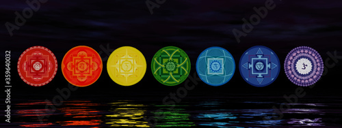 Seven chakra symbols on the horizon line by night 