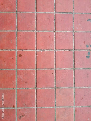 Background of orange clay floor tiles in square shape. Copy space.