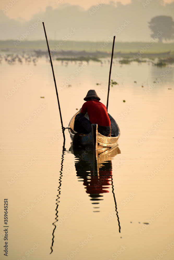 Local fisher man use fish net catch fish in Taungthaman lake near u-bein bridge, Mandalay, Myanmar (Burma)
