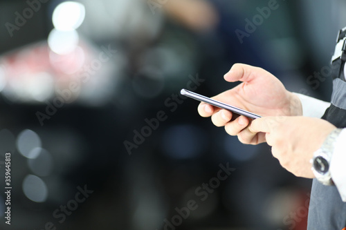 Close up of young man hands texting message on modern smartphone